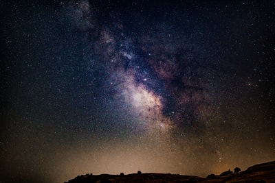 silhouette of mountain under starry night